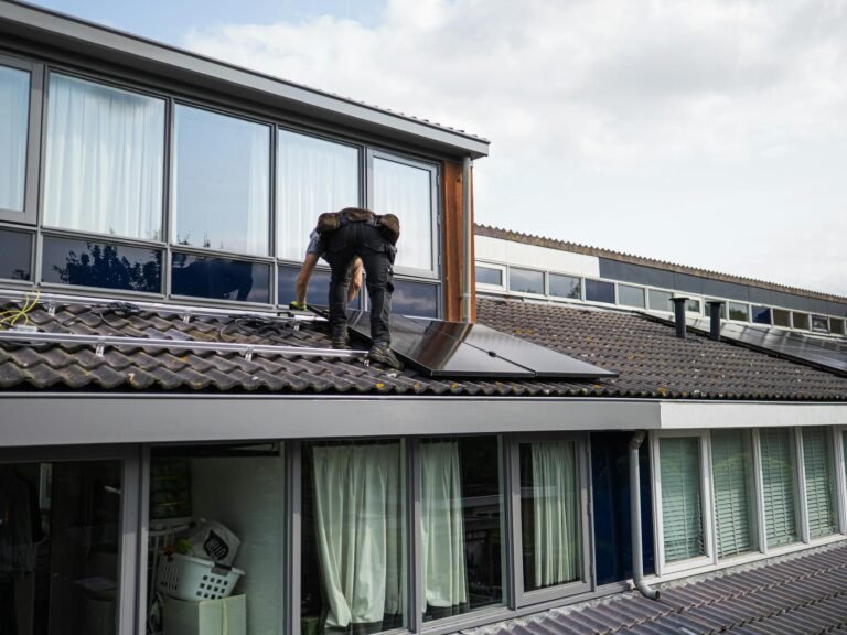 solar panels being installed on a UK residential roof, installer on scaffold